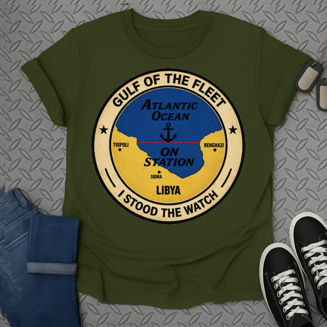 Green t-shirt with a circular logo featuring a ship's anchor over the words "On Station".